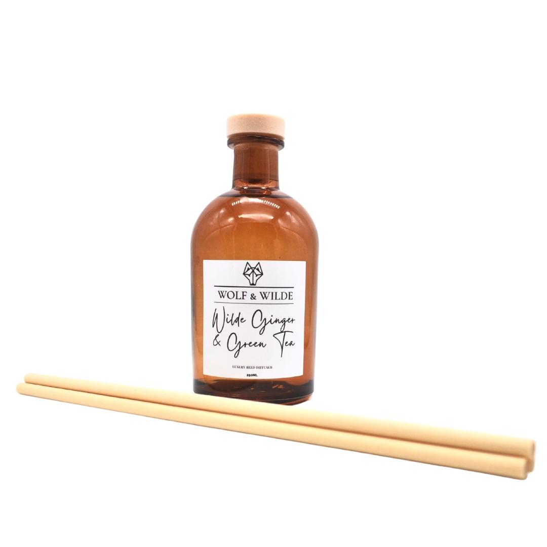 Wilde Ginger & Green Tea Apothecary Reed Diffuser in an amber bottle with natural reeds, showcasing its elegant design and eco-friendly materials.